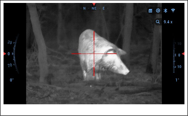 Iron-red thermal view of a wild hog in the woods through an ATN thermal scope
