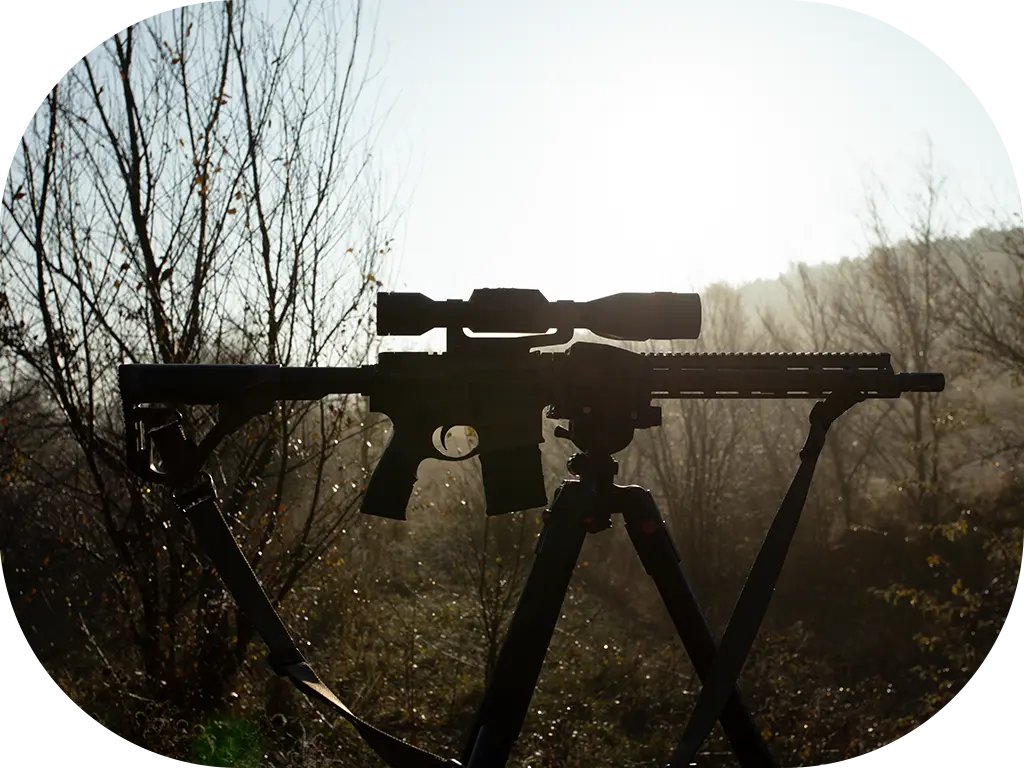 Hunter in the field using an ATN scope at dusk