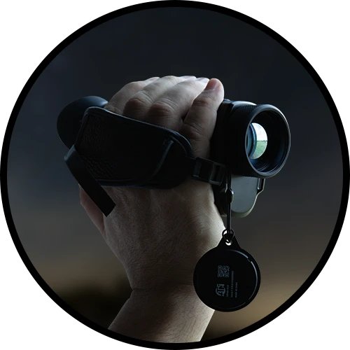 Hunter aiming a rifle fitted with an ATN X-Sight 5 day and night scope at dusk
