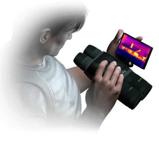 Hunter aiming a rifle fitted with an ATN X-Sight 5 day and night scope at dusk