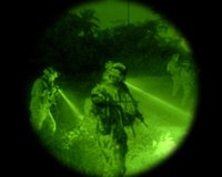 Hunter in the field using an ATN scope at dusk