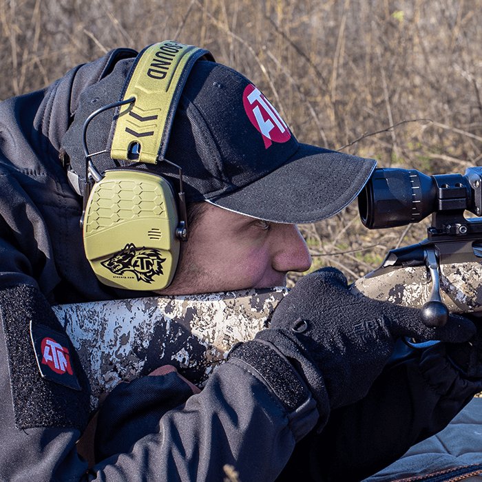 Hunter in the field using an ATN scope at dusk