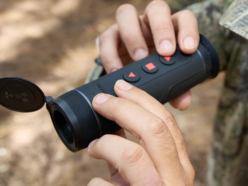 Hunter in the field using an ATN scope at dusk